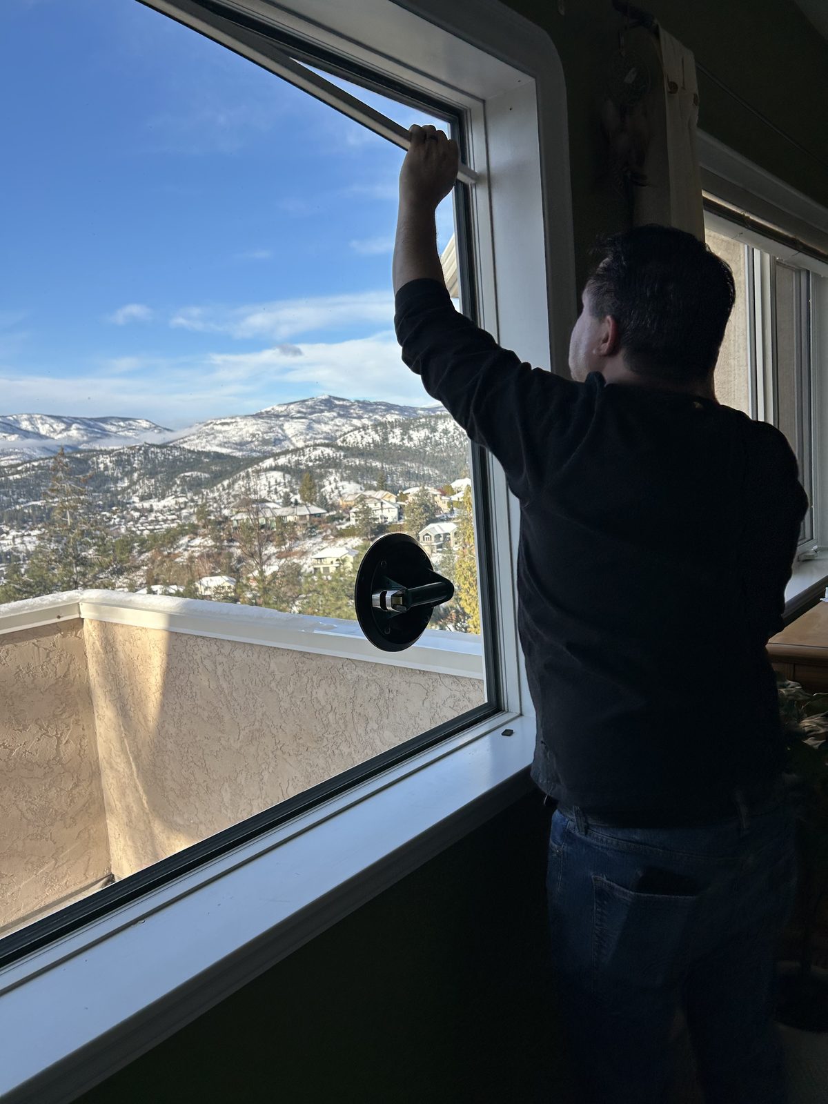 The Loyalty Glass team fitting a new picture window above Okanagan Lake
